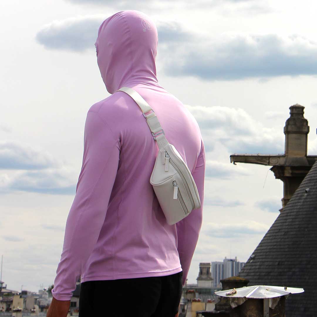 Man in an urban area wearing streetwear outfit, and white streetwear bum bag from cawa.me