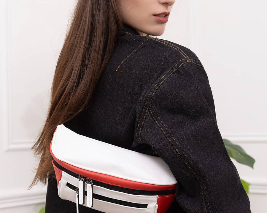 Woman wearing streetwear outfit with a white and red streetwear bum bag from cawa.me in a white room