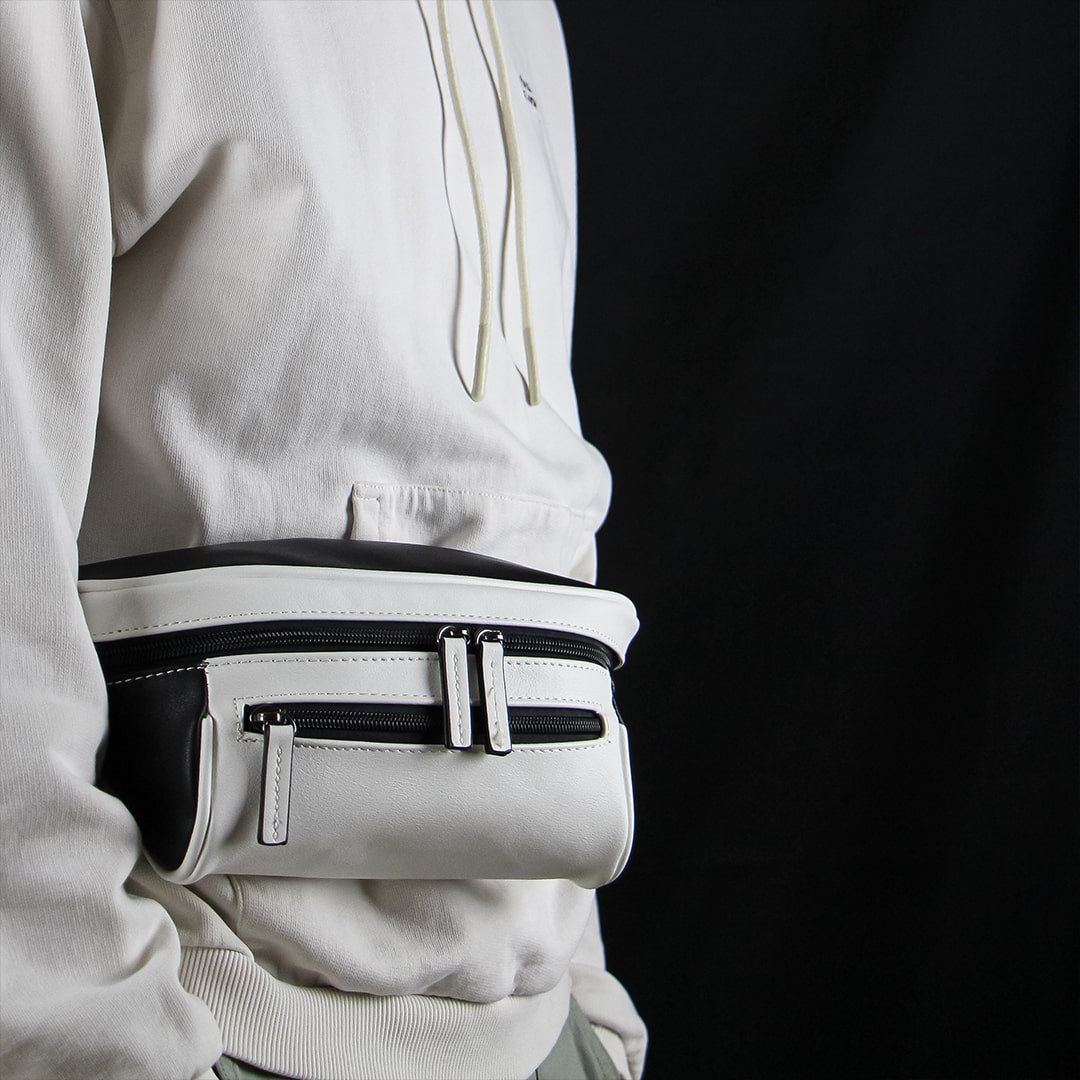 Man on a black background with a black and white streetwear bum bag from cawa.me