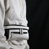 Man on a black background with a black and white streetwear bum bag from cawa.me