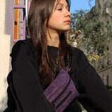 Woman in an urban area with a purple streetwear bum bag