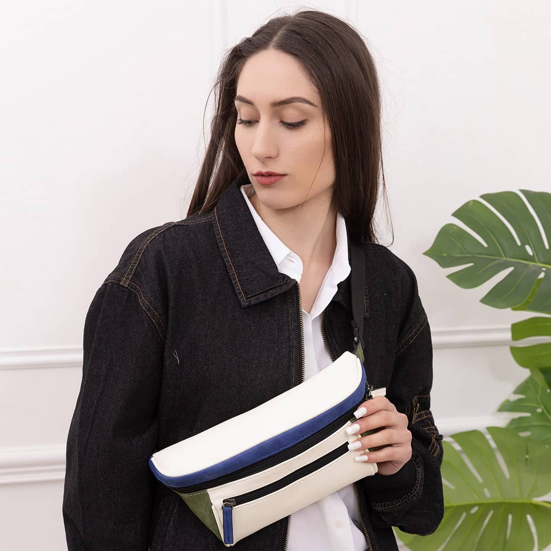 Woman in a white room with a white streetwear bum bag from cawa.me and a denim over shirt