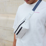 Man in an urban area with a white streetwear bum bag from cawa.me